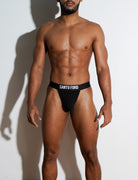 Man wearing black Santo Ford underwear against a white background